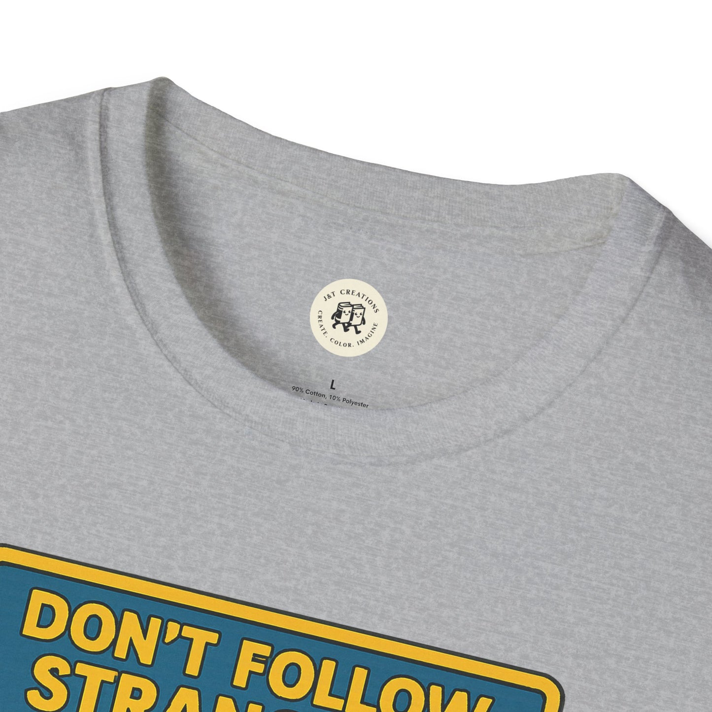 Close-up of gray Printify Alice in Wonderland graphic tee with yellow and blue text design