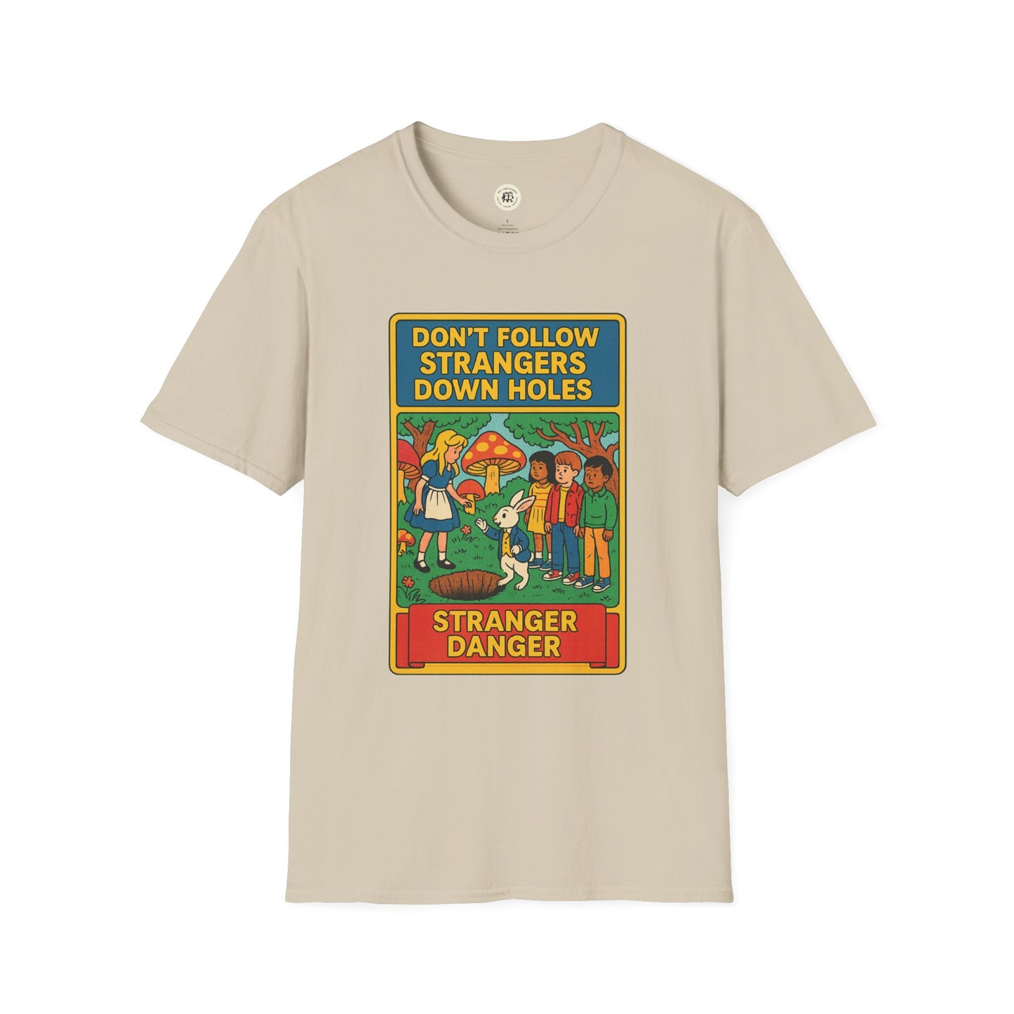 Beige Printify T-shirt featuring a colorful Alice in Wonderland graphic tee with text and character design