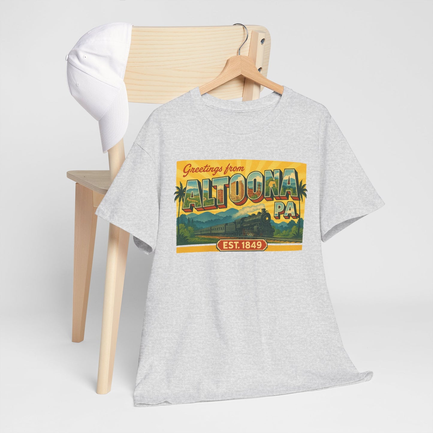 Light gray Altoona PA souvenir t-shirt with colorful vintage graphic print on front hanging on wooden chair