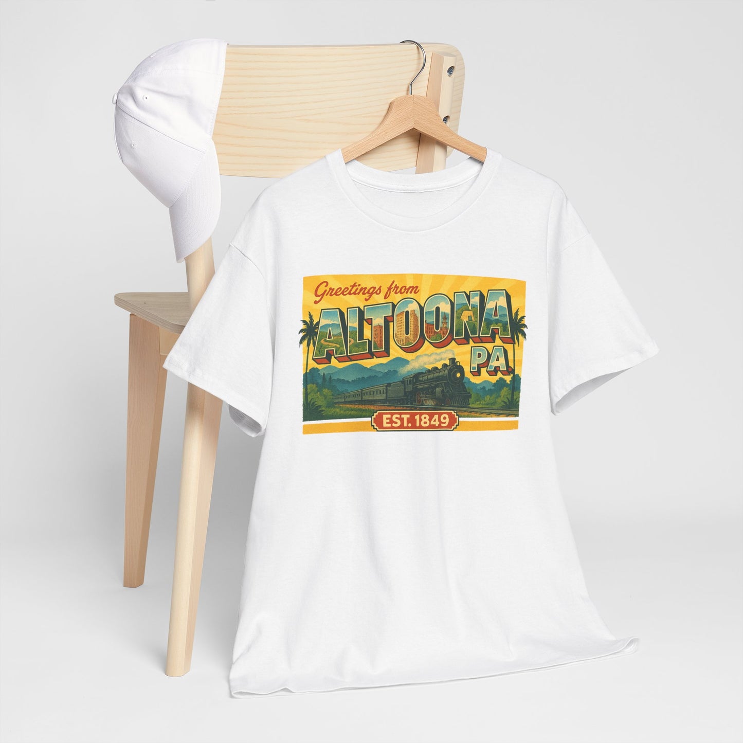 White Printify t-shirt with vintage style Altoona PA souvenir t-shirt design hanging on chair