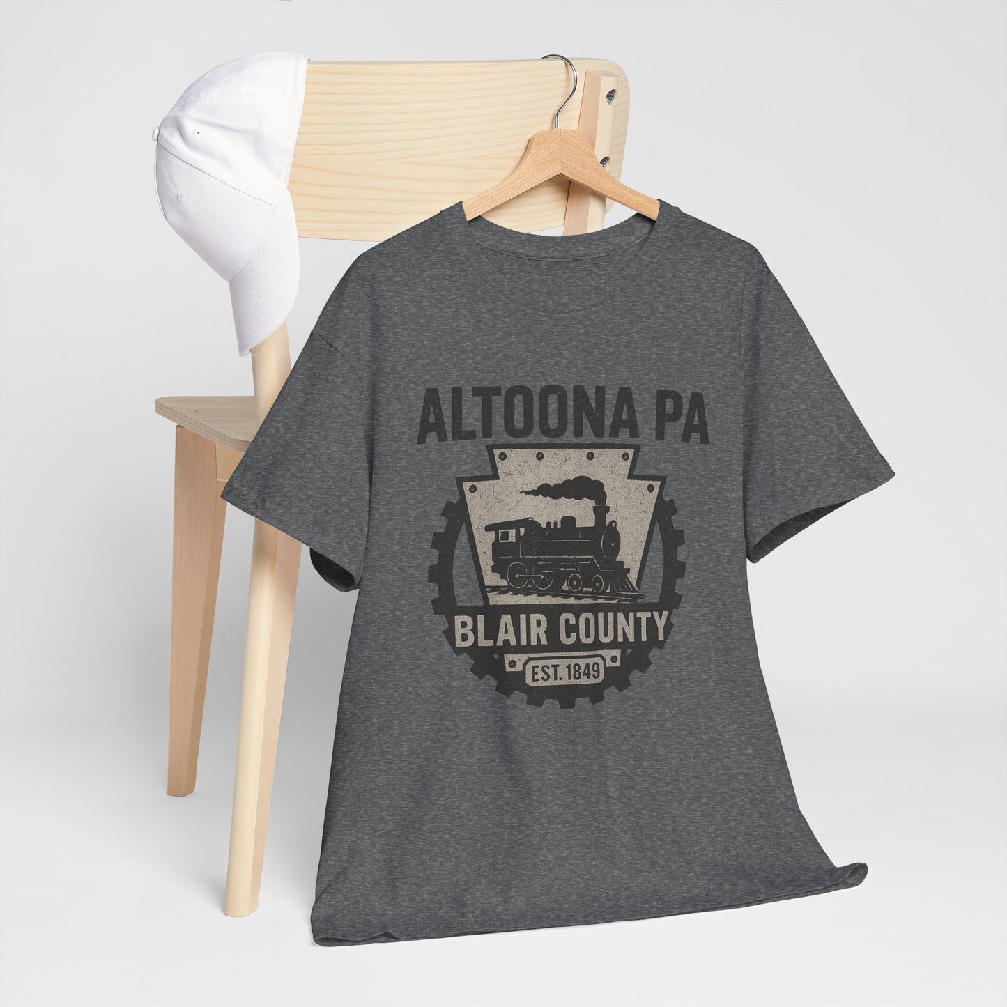 Dark gray Altoona PA t-shirt with Blair County train graphic hanging on wooden chair