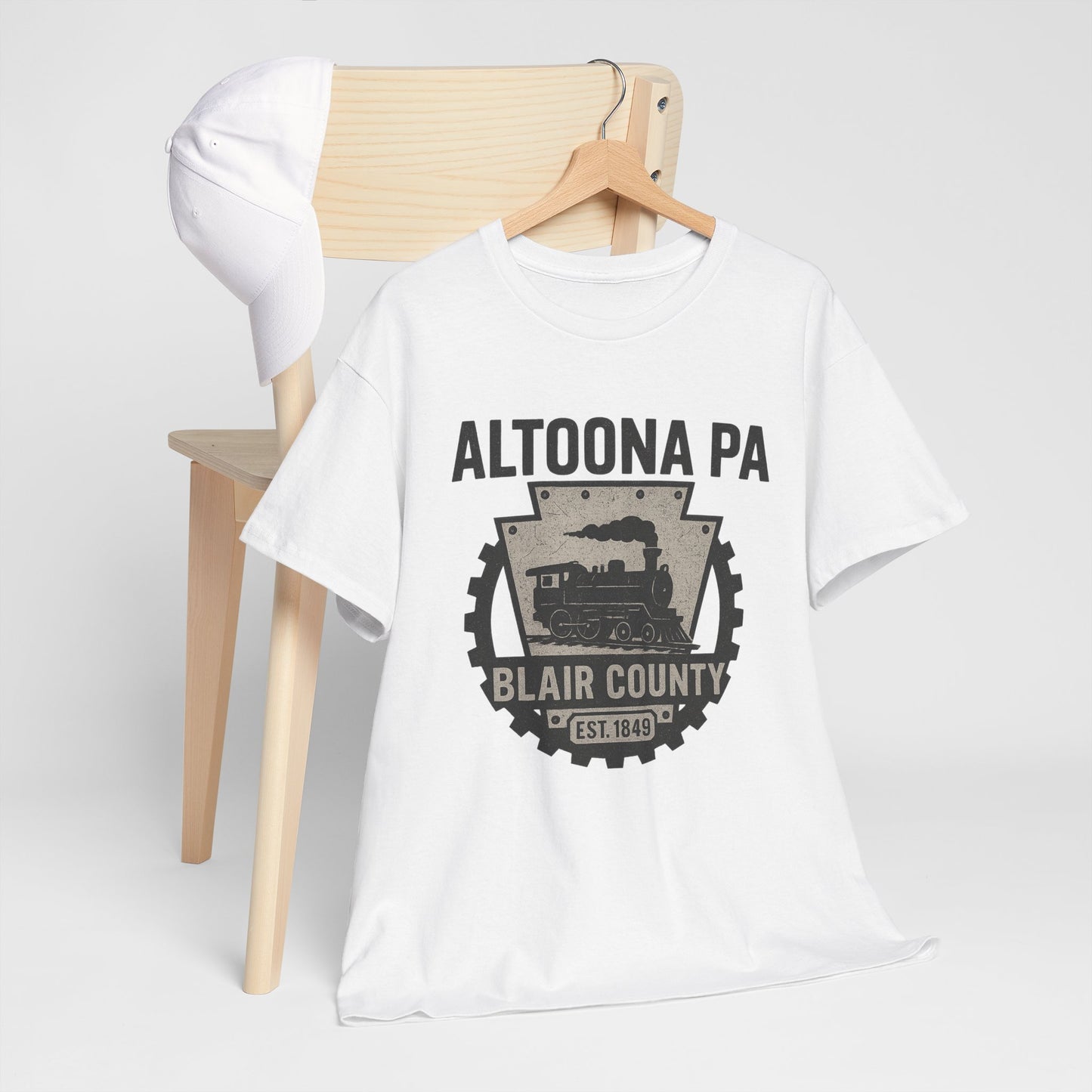White Printify Altoona PA t-shirt with vintage train and Blair County design on wooden chair