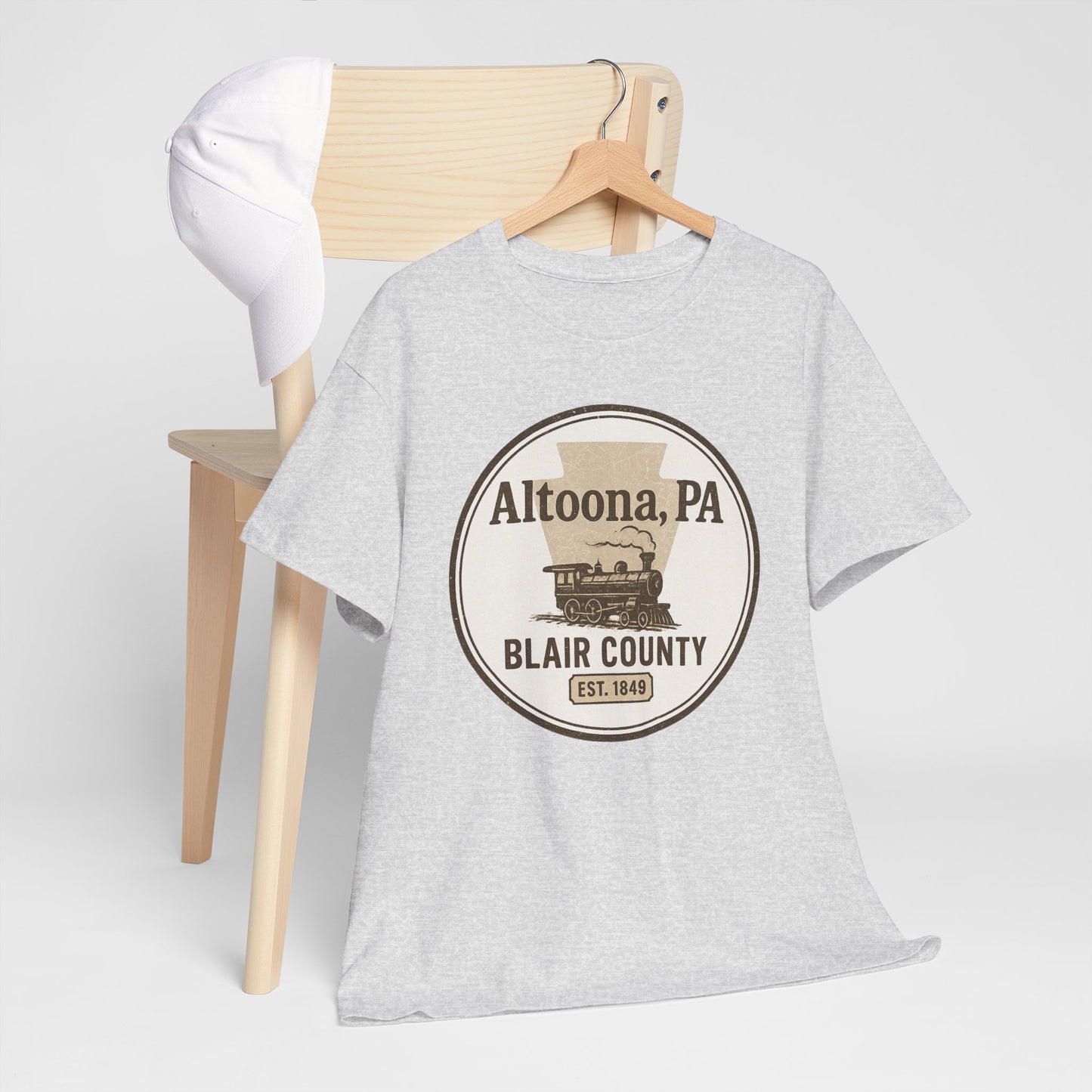 Gray Altoona PA vintage t-shirt with Blair County steam train design hanging on wooden chair
