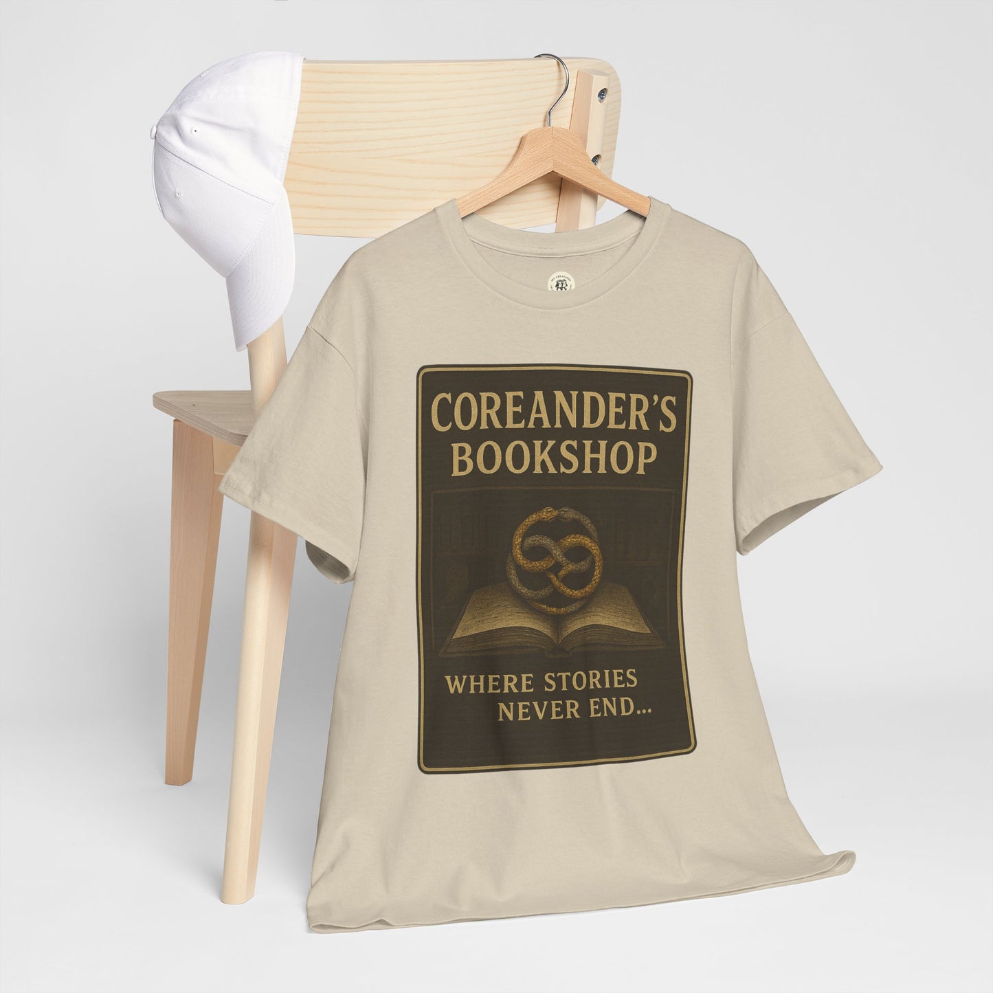 Printify beige Neverending Story t-shirt with Coreander's Bookshop graphic and text design