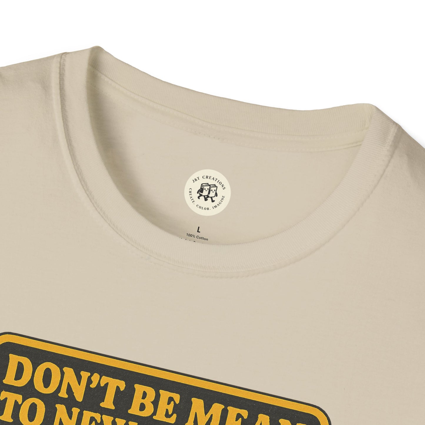 Close-up of beige Printify Ebenezer Scrooge empathy t-shirt with bold yellow text on front