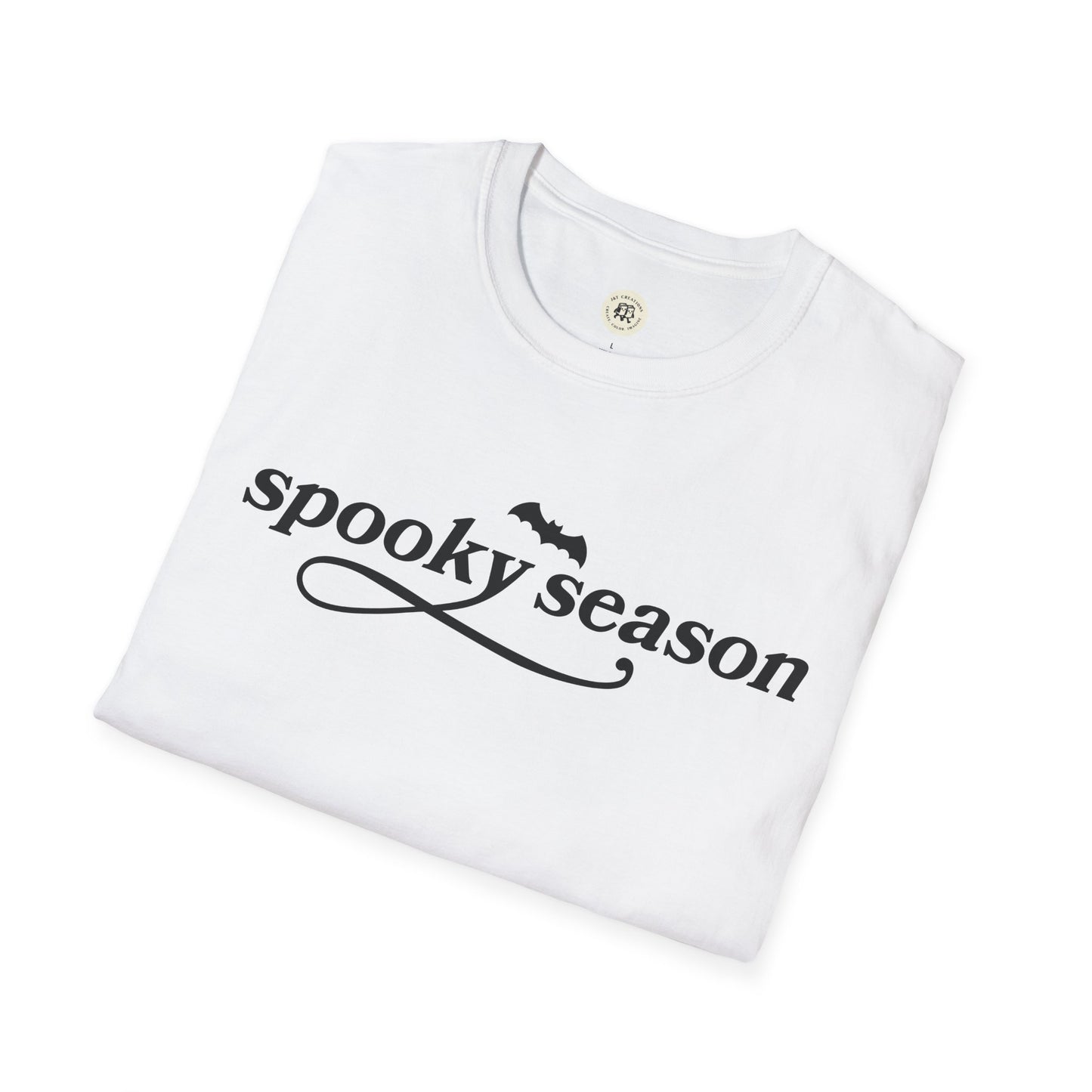 White folded eco-friendly Halloween t-shirt with spooky season text and bat graphic from Printify