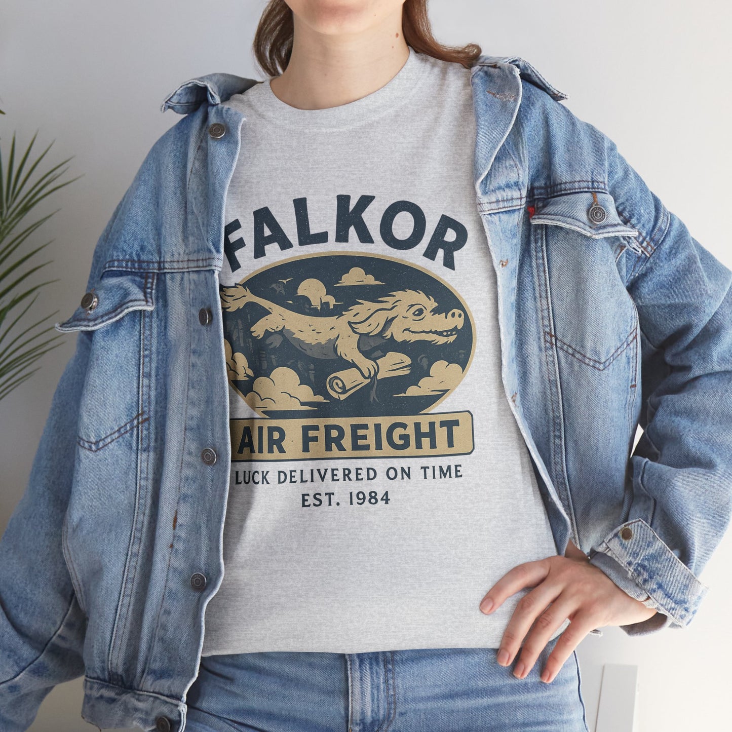 Gray Falkor Neverending Story t-shirt featuring vintage air freight graphic worn with denim jacket