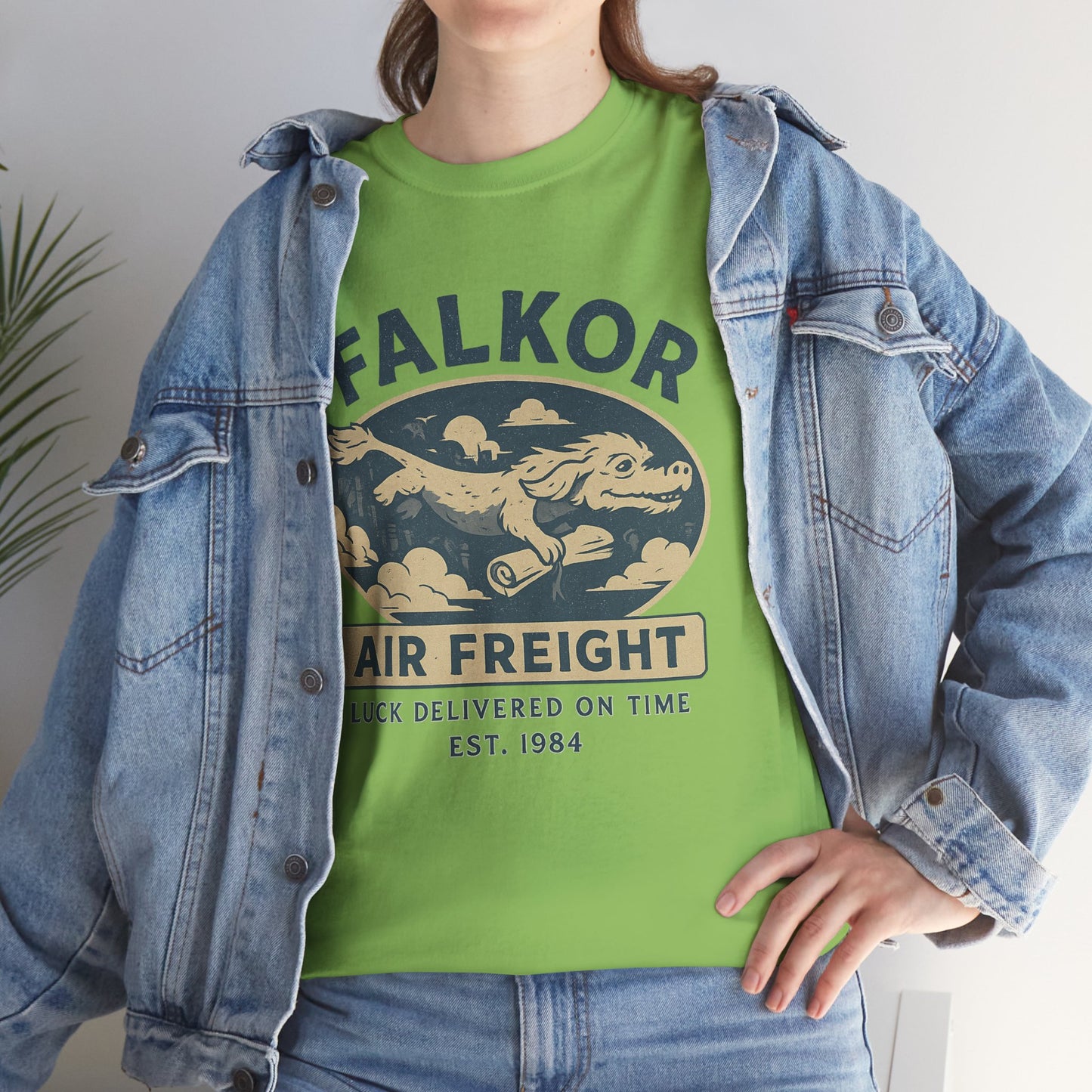Green Falkor Neverending Story t-shirt with vintage air freight design worn with denim jacket