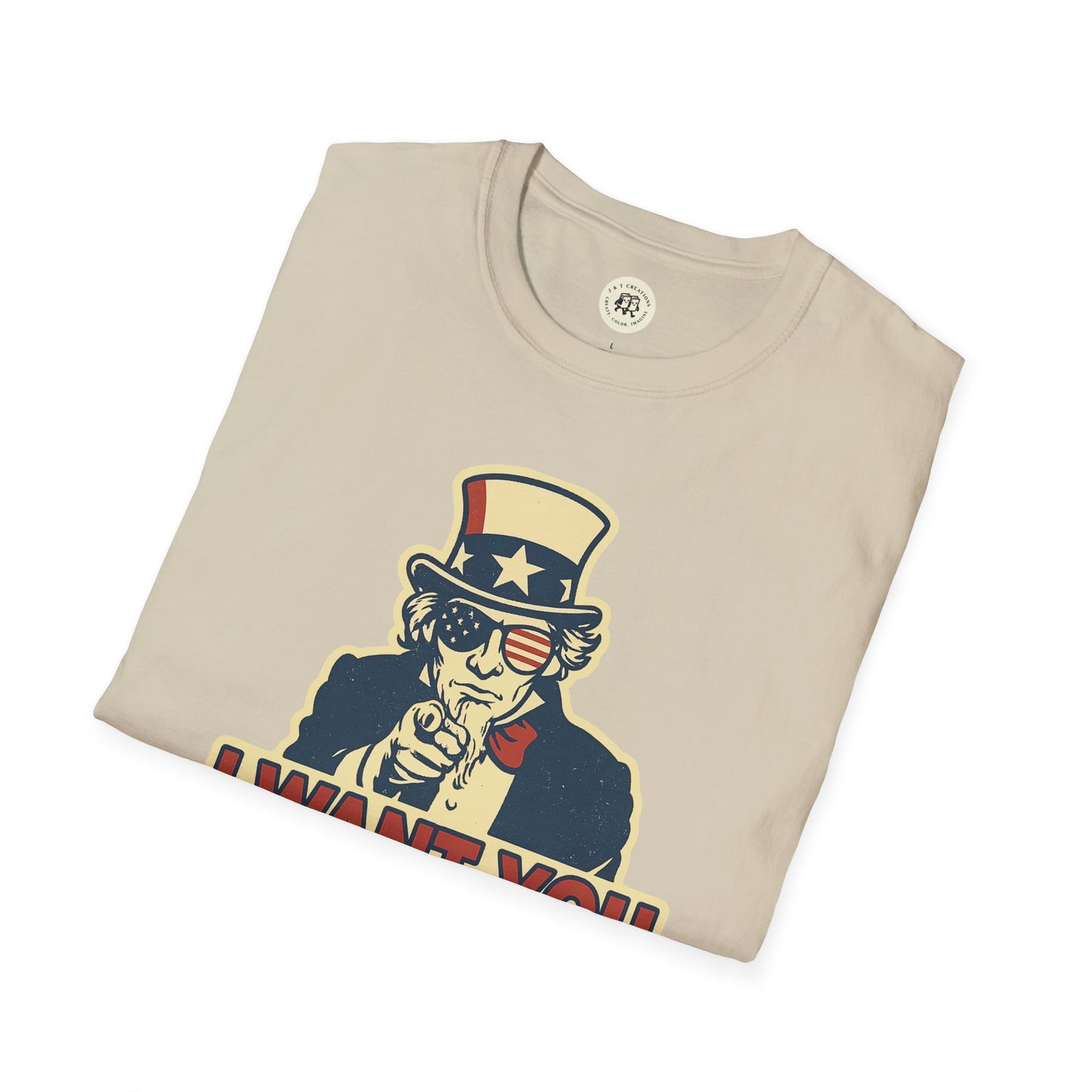 Printify beige funny Independence Day t-shirt featuring Uncle Sam with patriotic sunglasses and pointing gesture