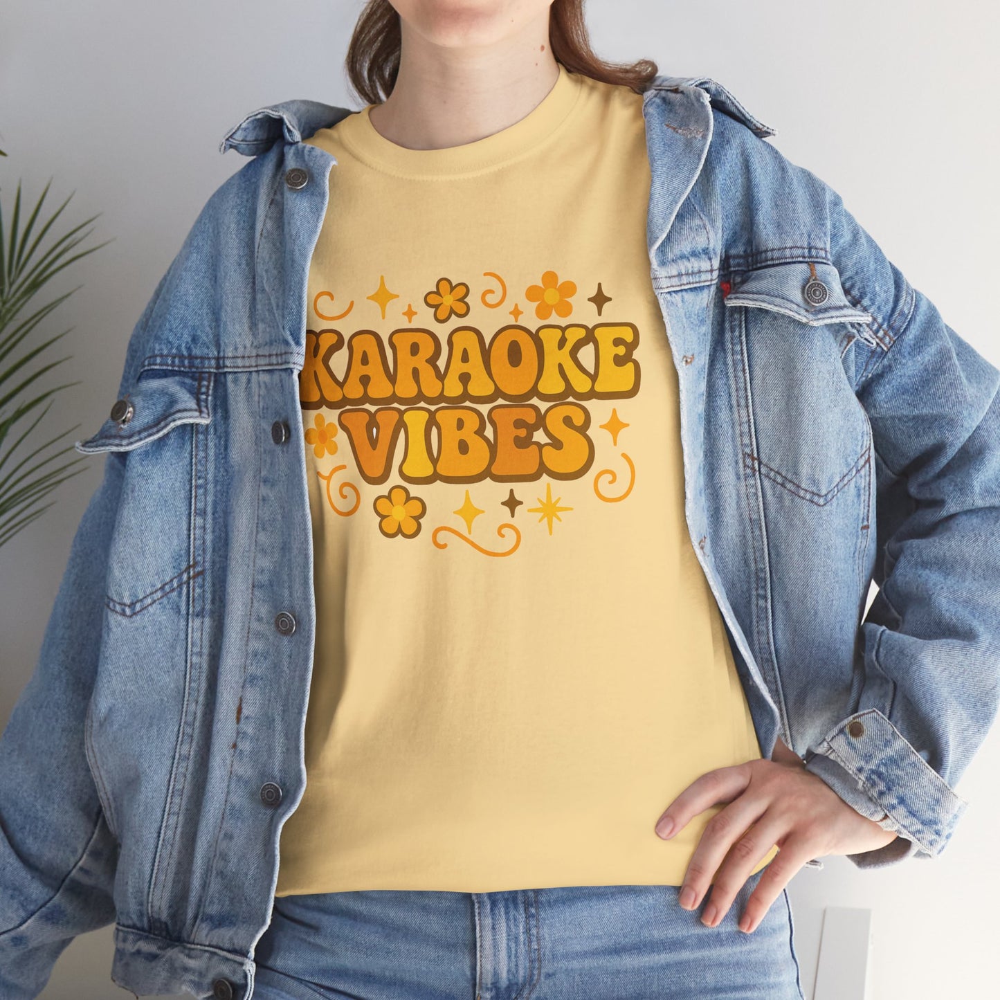 Yellow karaoke vibes t-shirt with retro floral design worn with denim jacket by Printify