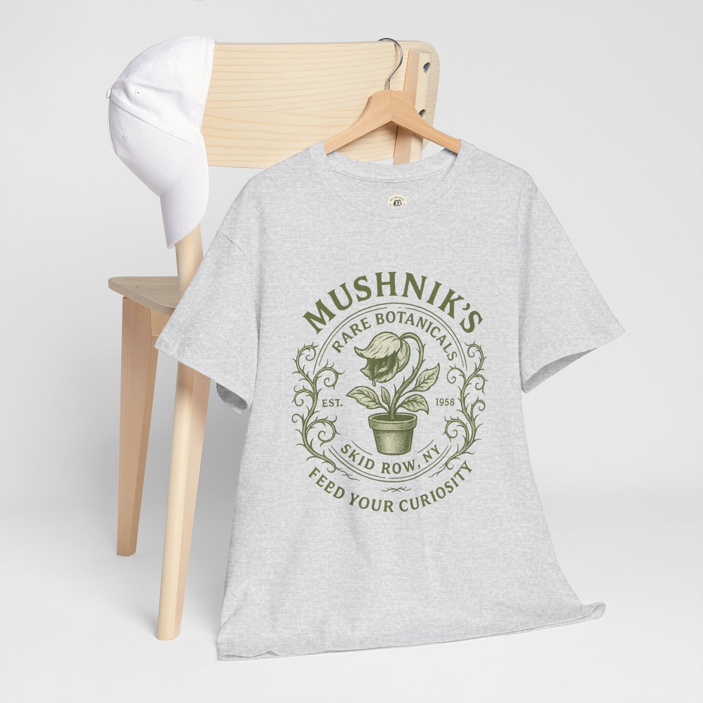 Printify Little Shop of Horrors t-shirt in gray with green botanical plant graphic on chair