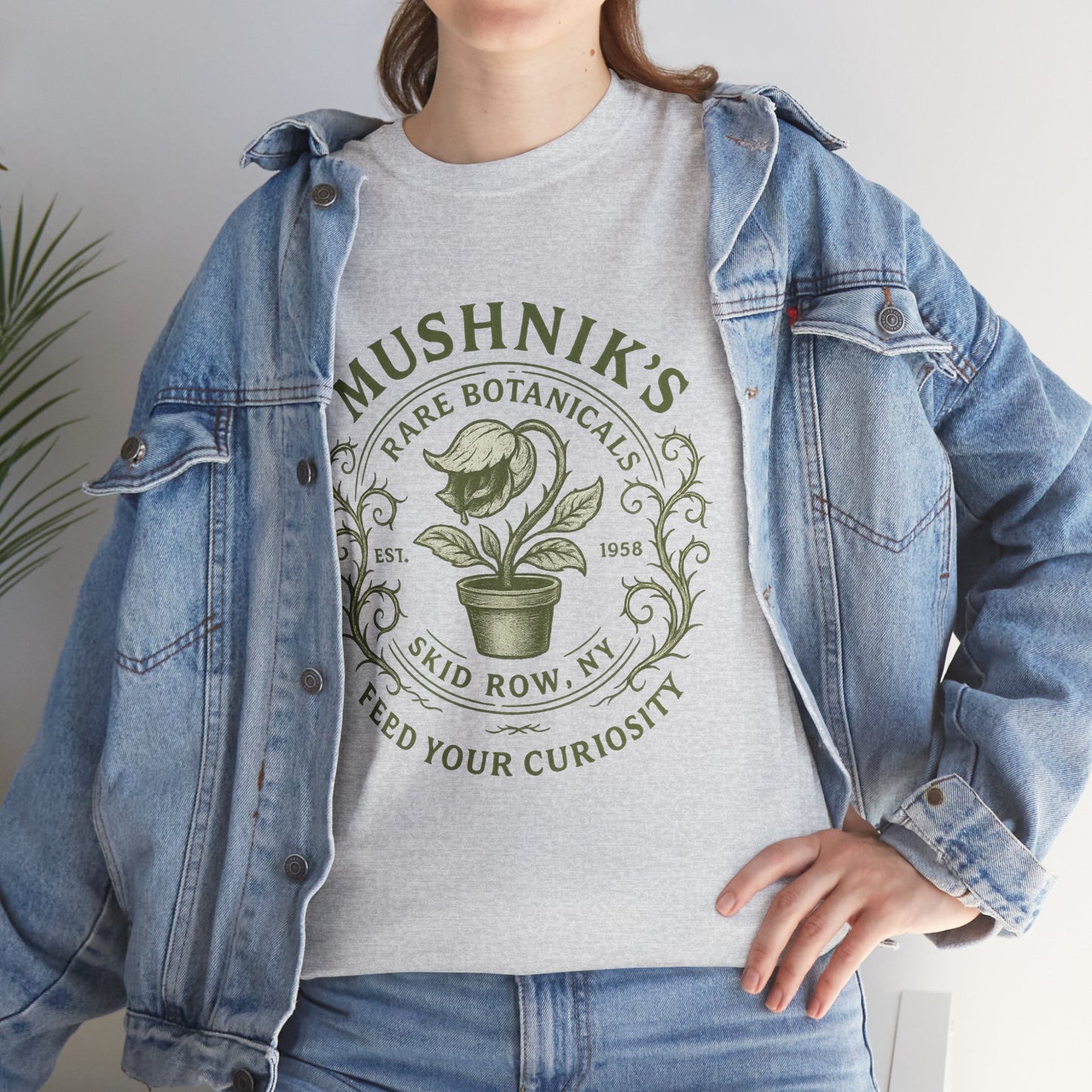 Gray Little Shop of Horrors t-shirt featuring Mushnik's Rare Botanicals design worn with denim jacket