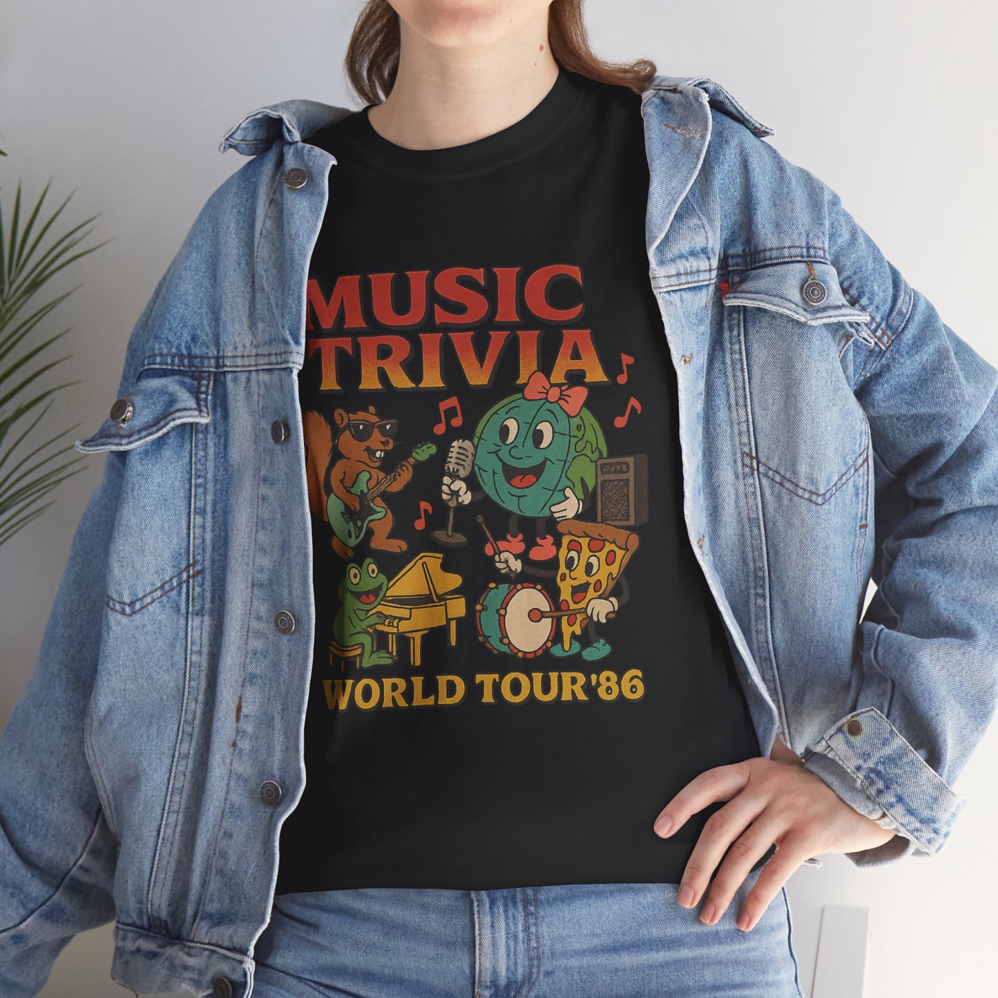 Black music trivia t-shirt with colorful cartoon characters and world tour 86 design worn with denim jacket