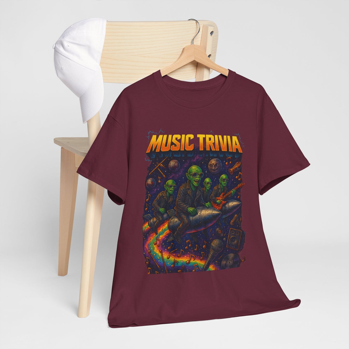 Printify maroon music trivia t-shirt with colorful alien band design hanging on wooden chair