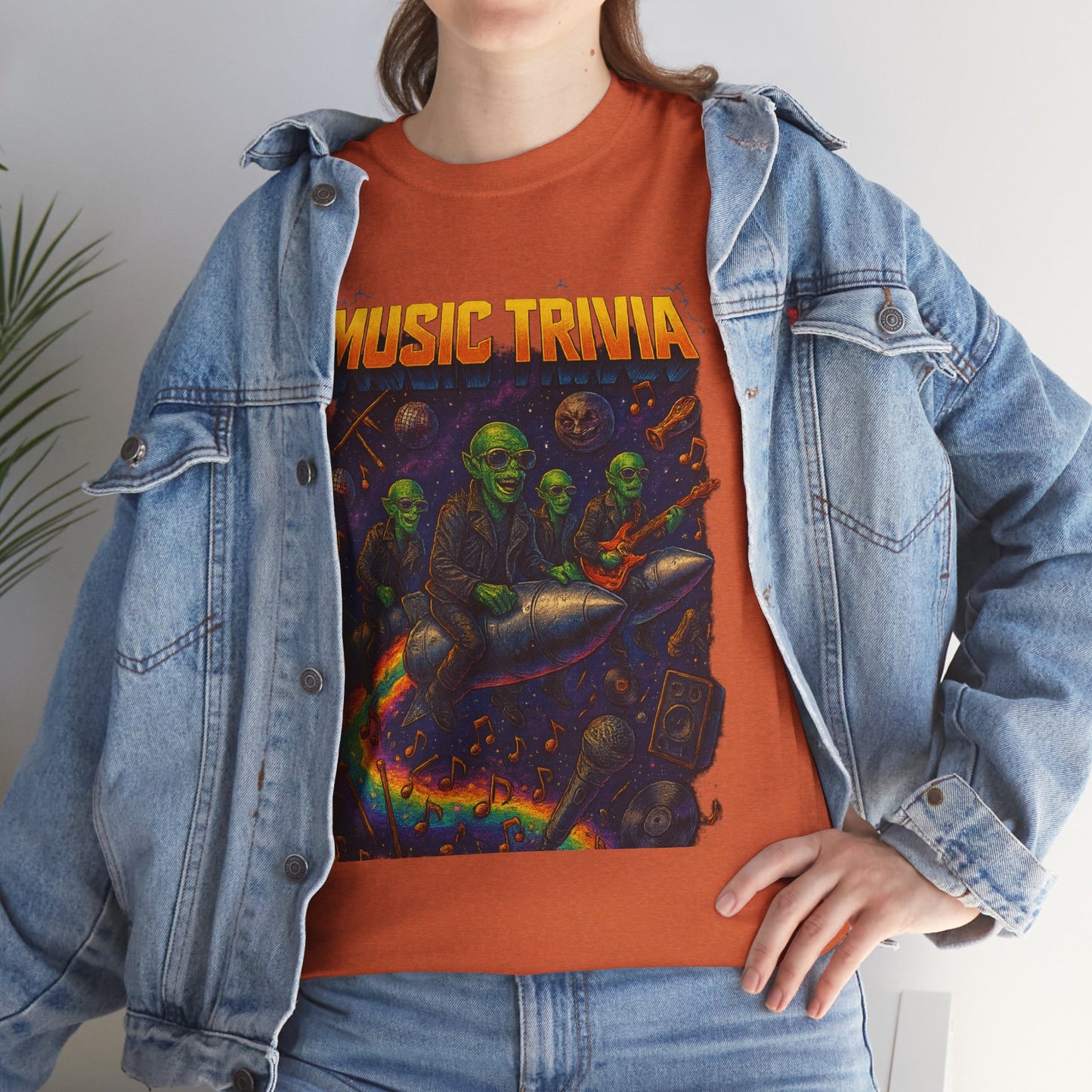 Orange music trivia t-shirt with colorful alien musicians design worn under denim jacket