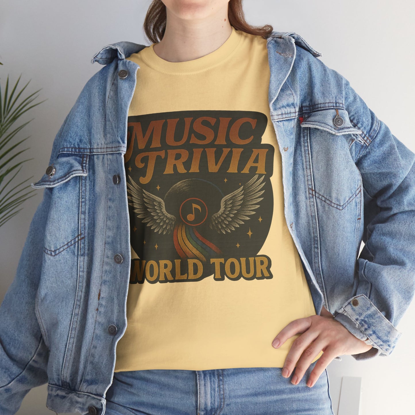 Music trivia t-shirt with world tour graphic worn under a denim jacket on a person