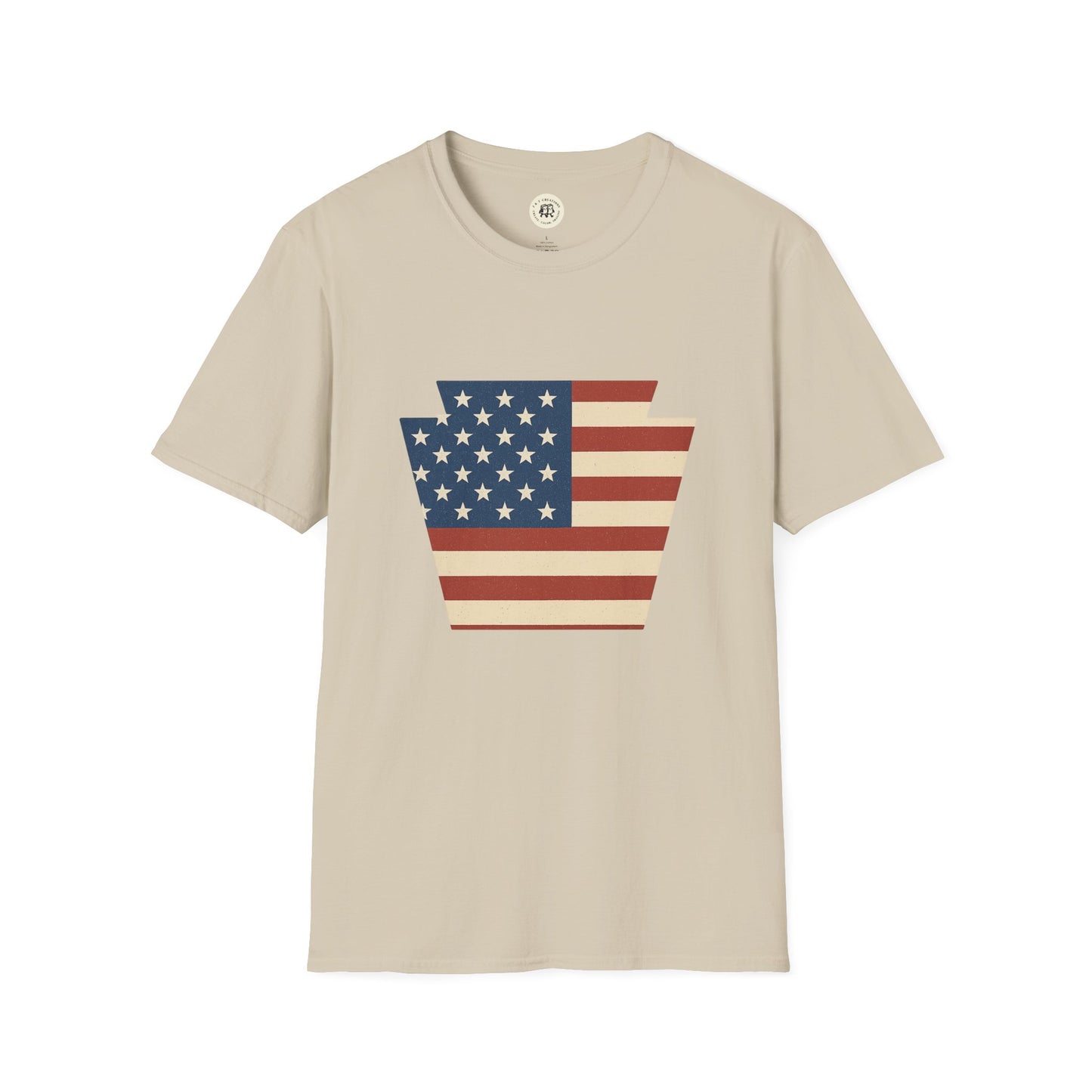 Printify beige T-shirt featuring Pennsylvania Keystone American flag shirt design in red white and blue