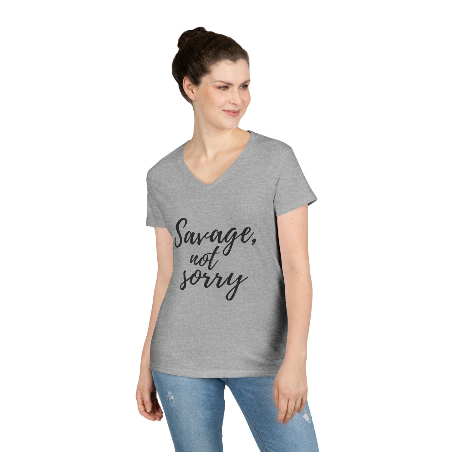 Gray Printify savage v-neck t-shirt with black text reading Savage not sorry worn by woman