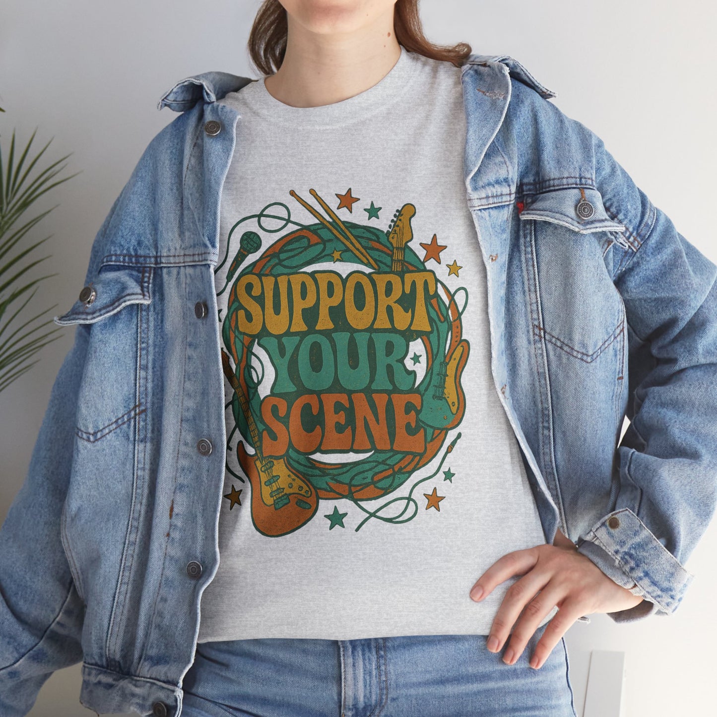 Support your scene t-shirt with colorful music-themed graphic worn under denim jacket