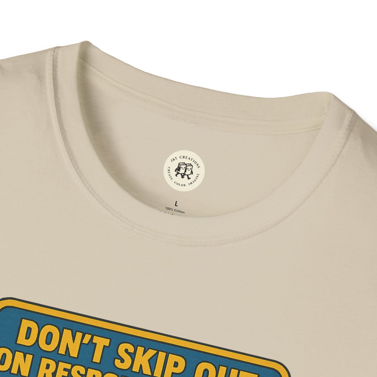 Close-up of Printify Tom Sawyer vintage t-shirt cream color with bold yellow and blue text design