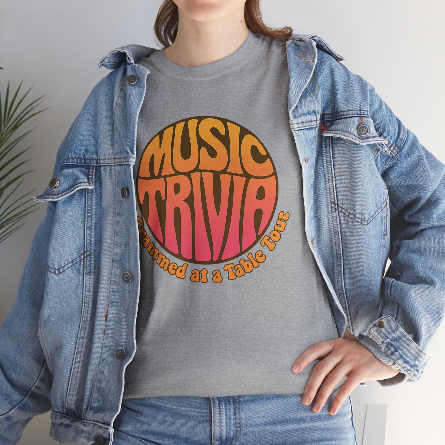 Vintage music trivia t-shirt in gray with colorful retro text worn under a denim jacket