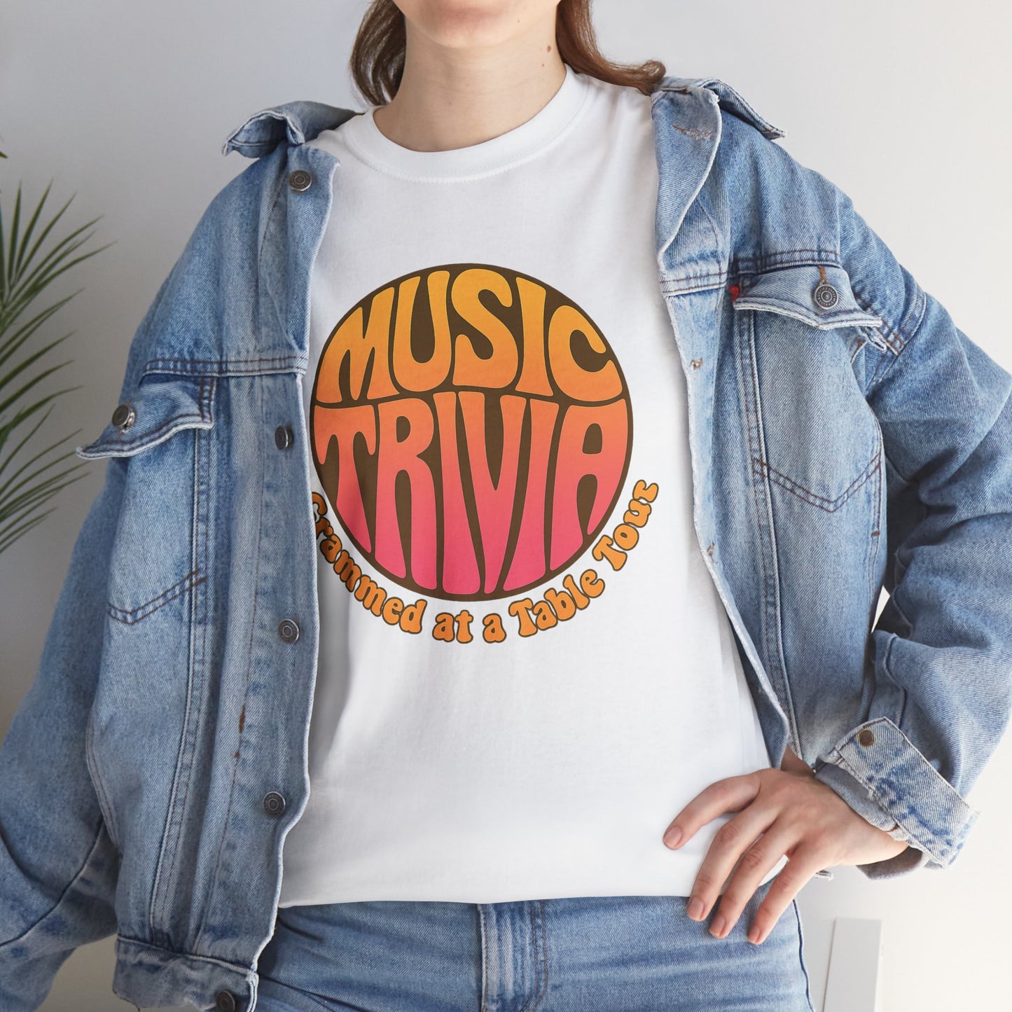 White vintage music trivia t-shirt with colorful retro design worn under denim jacket