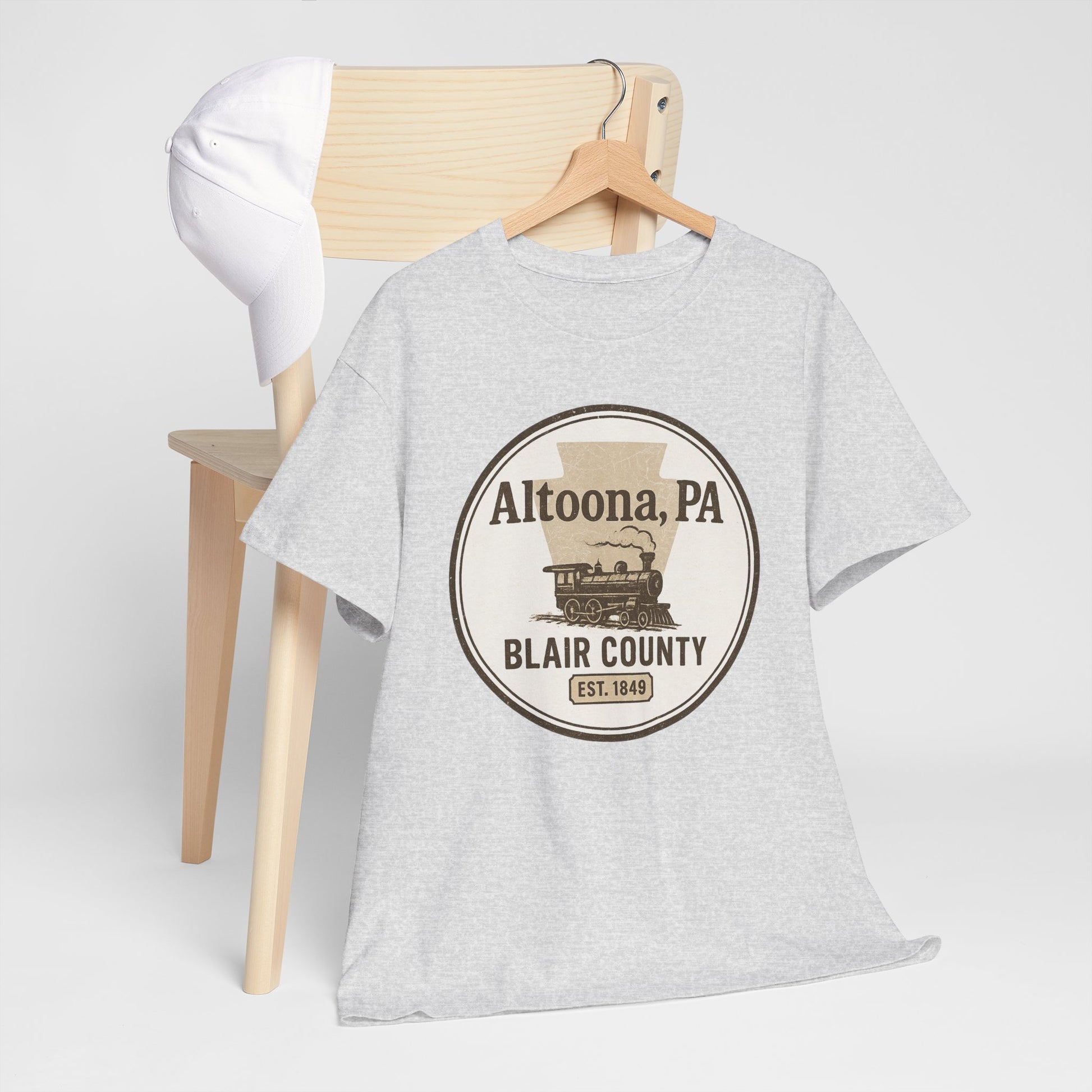 Gray Altoona PA vintage t-shirt with Blair County steam train design hanging on wooden chair