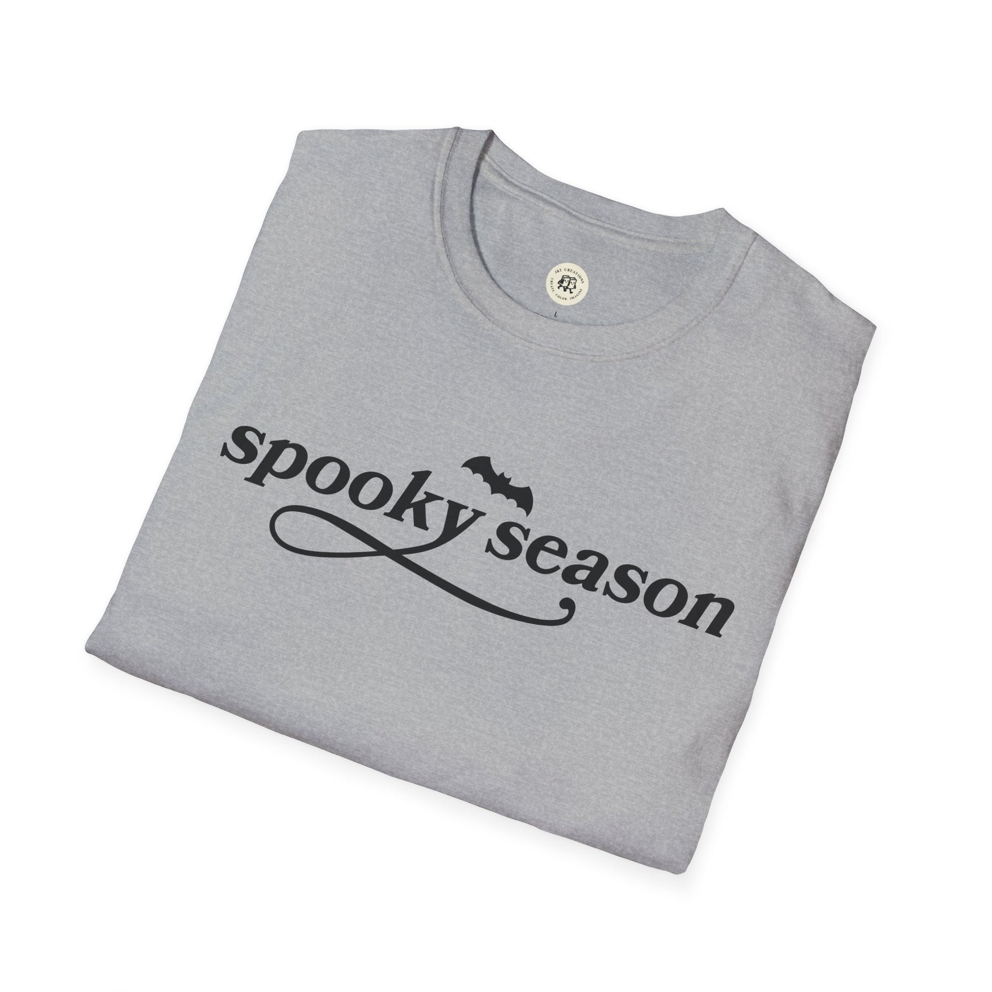Gray folded eco-friendly Halloween t-shirt with spooky season text and bat graphic by Printify