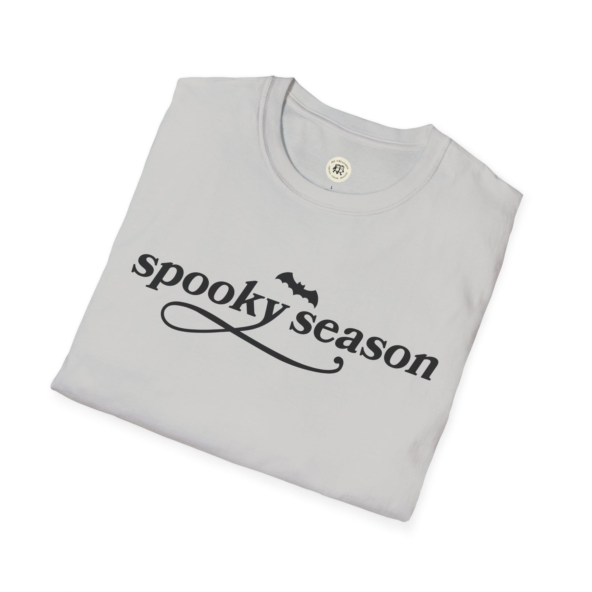 Folded Printify eco-friendly Halloween t-shirt in light gray with spooky season text and bat graphic
