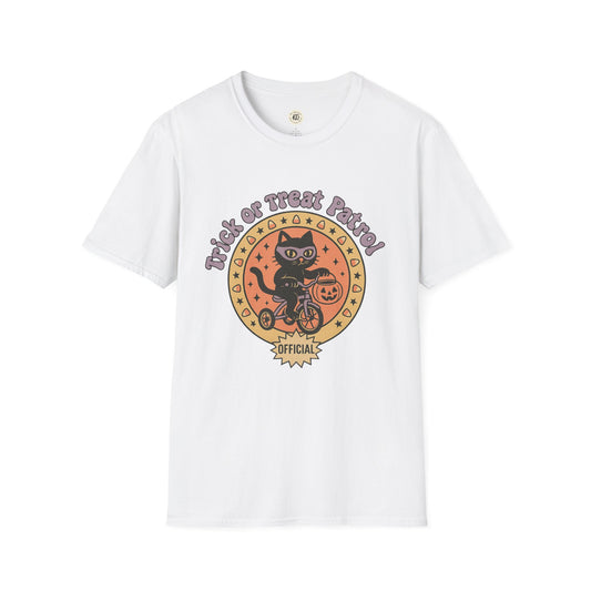 White Printify t-shirt featuring a Halloween cat t-shirt design with a black cat on a bike holding a pumpkin bucket