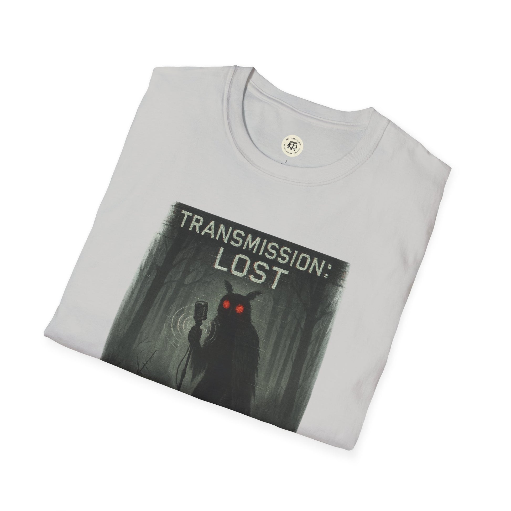 Folded mysterious lost transmission t-shirt by Printify featuring dark forest and red-eyed figure graphic
