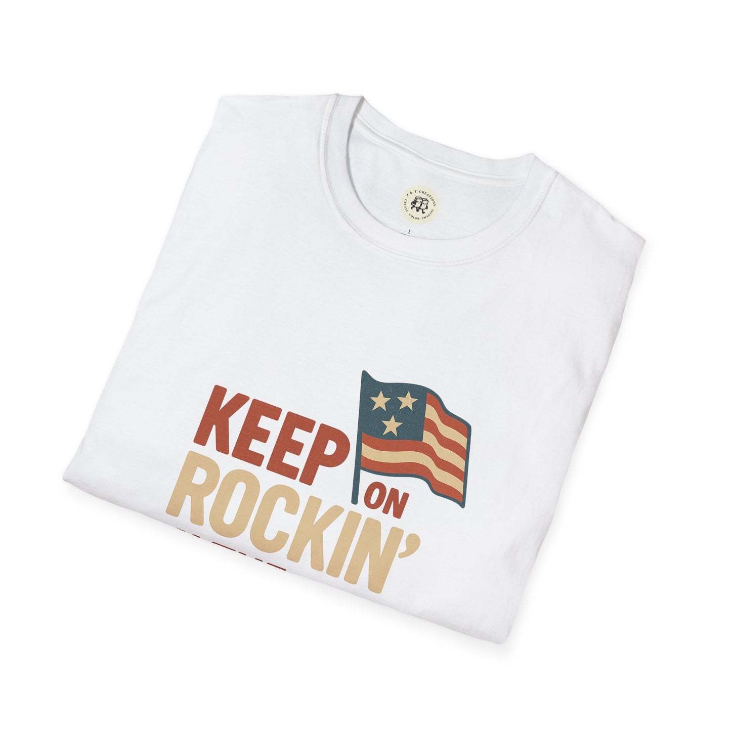 White folded Keep on Rockin' in the Free World shirt with patriotic flag graphic by Printify