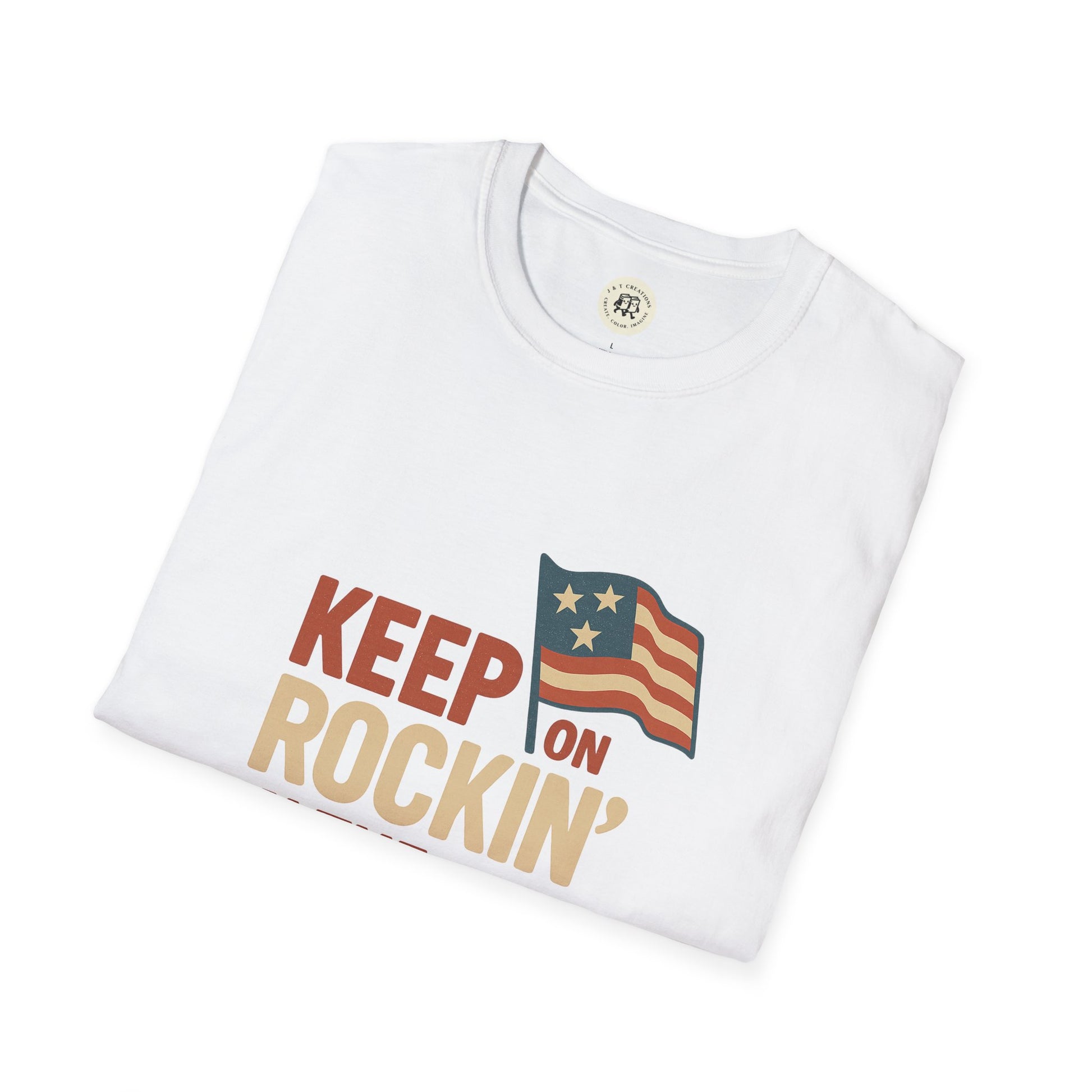 White folded Keep on Rockin' in the Free World shirt with patriotic flag graphic by Printify