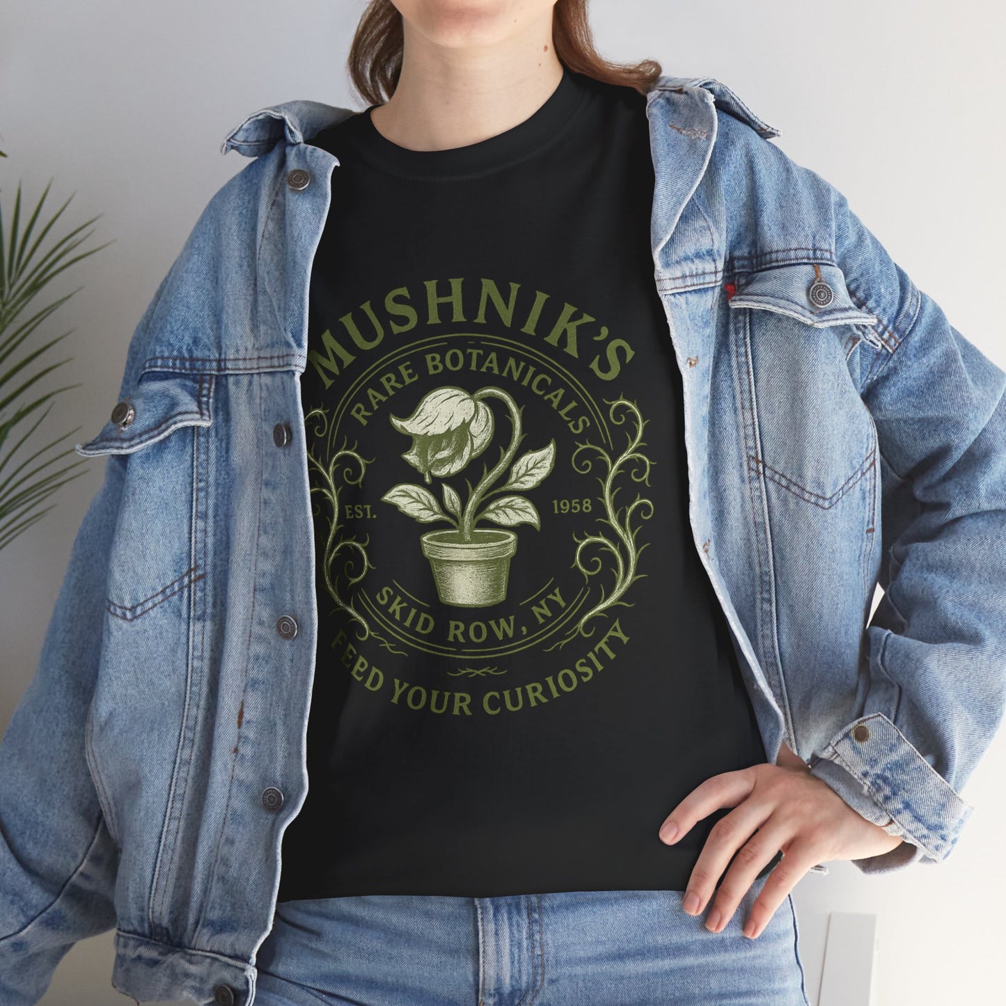 Black Little Shop of Horrors t-shirt with Mushnik's Rare Botanicals plant design worn with denim jacket