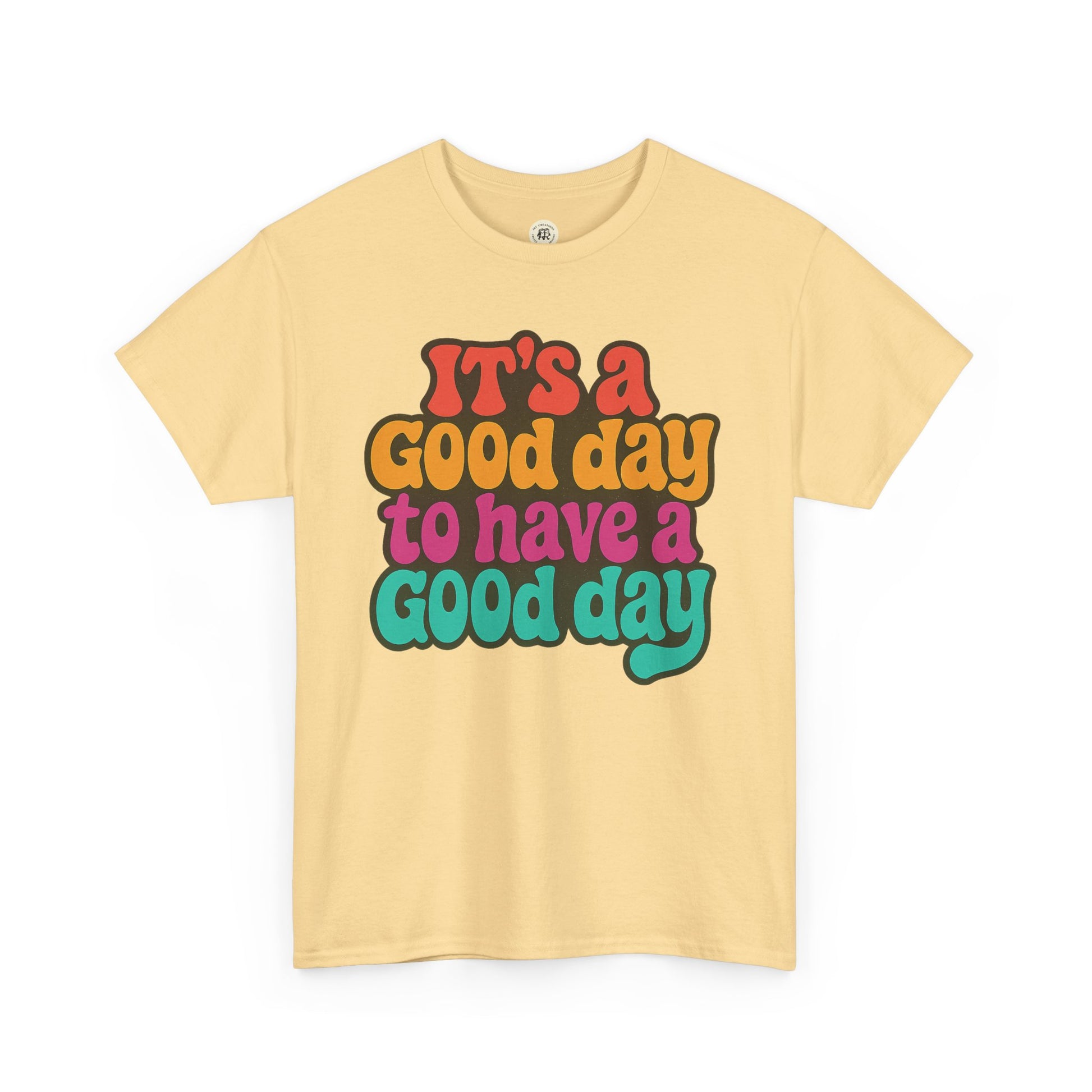 Printify positive vibe t-shirt with colorful text It's a Good Day to Have a Good Day on yellow fabric