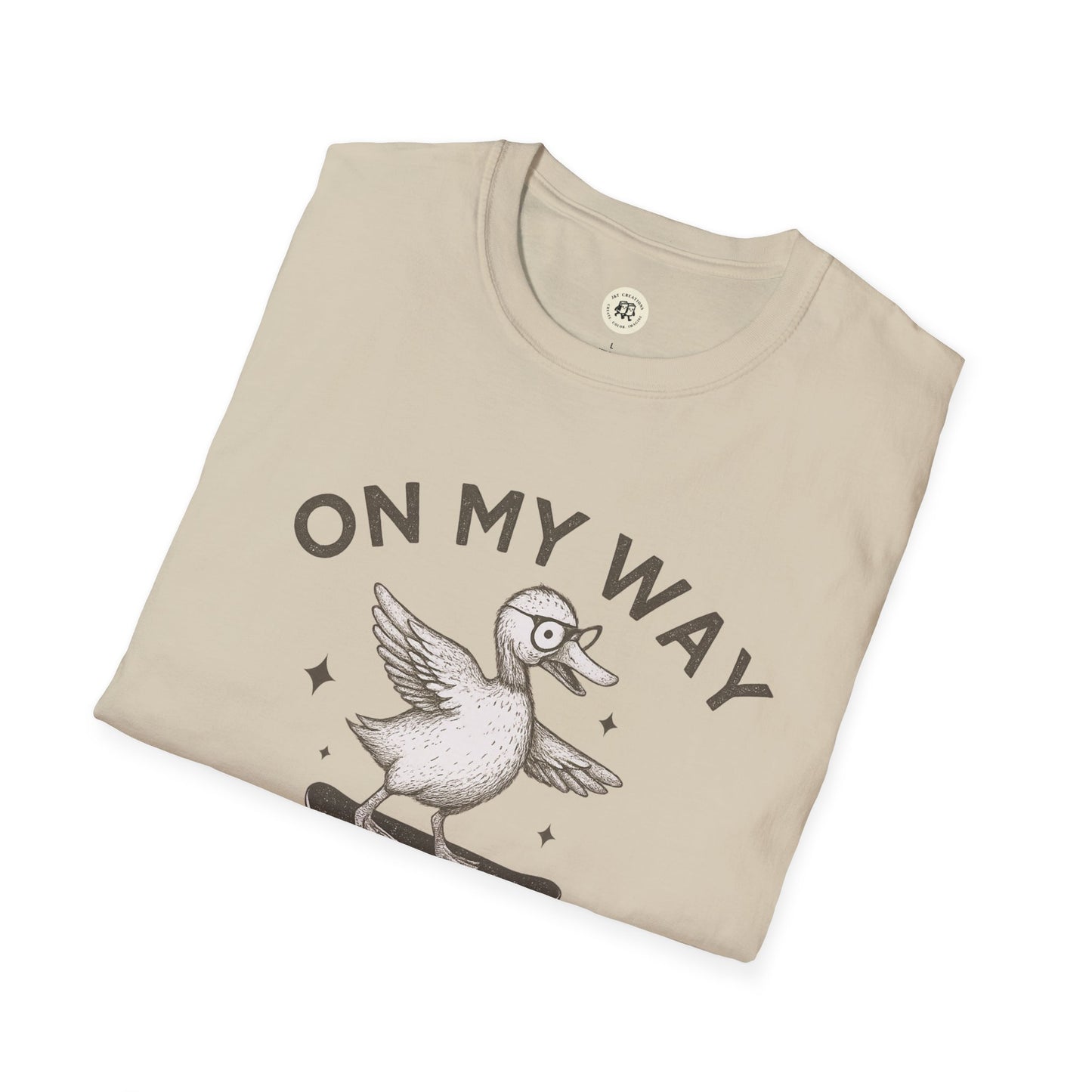 Beige quirky duck t-shirt by Printify featuring a duck on a skateboard with text on my way